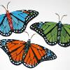 3 tack-fused monarch butterflies. They are flat now, but will be slumped slightly in the wings to look like they are flying. Two of these will be included in mosaics. They are 3"x6" each. 