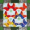 KKaleidescopic Butterfly:
11.5"x11.5" fused mosaic quilt, with bits of dichroic glass for the bodies and spots on the wings. The border has alternating strips of glass that has been stamped with enamel and silver mica.